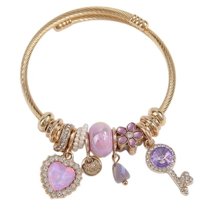Gold charm bracelet with purple heart zircon, handmade tag, and crystal key pendant