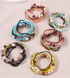Detailed flat lay of multilayer bohemian bead bracelet sets in diverse color palettes