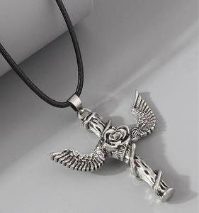 Macro shot of retro gothic sword pendant with detailed rose, wings and silver finish