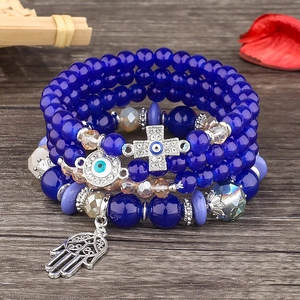 Blue beaded multi-layer bracelet with evil eye hamsa hand and cross charms