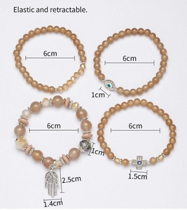 Detailed size view of four bohemian elastic bracelets with Hamsa Hand and Evil Eye charms