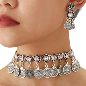 Vintage Middle Eastern jewelry set with pink crystals and embossed coin pendants on model