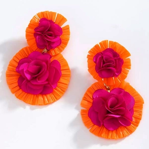 Detail of bohemian dual-layer floral earrings in vibrant orange and magenta satin