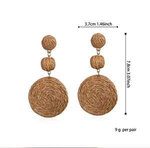 Detail of bohemian woven raffia earrings with dimensions 7.8cm length and 3.7cm width