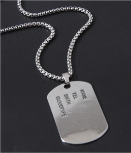 Macro shot of silver stainless steel dog tag pendant with customizable ID details