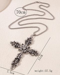 Detail view of large vintage cross pendant with crystals measuring 11cm by 7.5cm