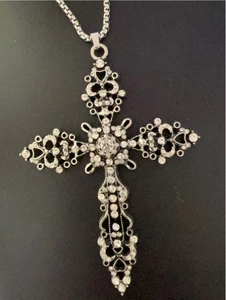 Close-up of vintage gothic cross pendant with sparkling rhinestones on a box chain
