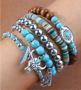 Detail of 5-piece bohemian layered bracelets with turquoise beads and western charms