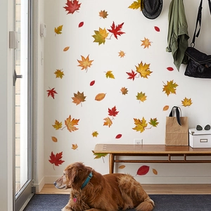 Cozy home entryway scene featuring autumn maple leaf wall stickers on a white wall
