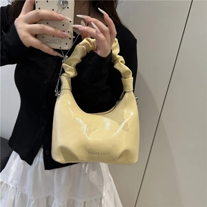 Fashionable yellow pleated handbag with bow chain strap and shiny patent finish