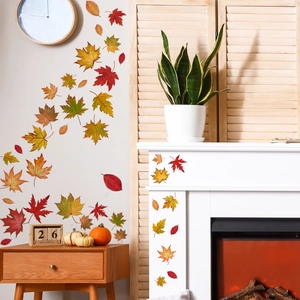 Detailed view of autumn maple leaf wall stickers applied to a home living room wall