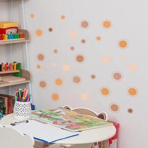 Detailed view of bohemian style sun wall stickers in warm tones for home decoration