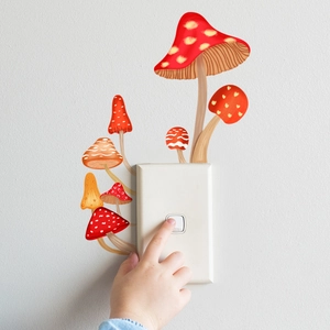 Detailed view of hand-drawn mushroom light switch wall stickers on a clean white wall