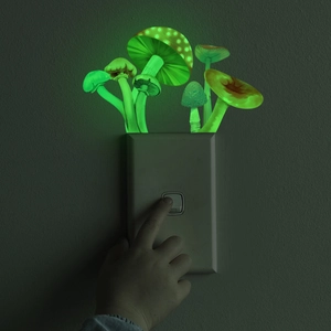 Luminous mushroom wall stickers glowing in the dark above a light switch panel
