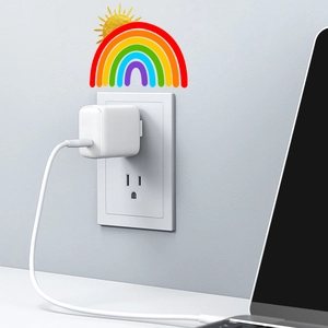 Detailed view of luminous rainbow and golden sun stickers applied above a wall power outlet
