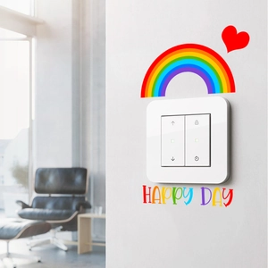 Close-up of smart light switch with colorful rainbow stickers and Happy Day text
