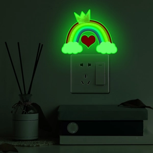 Luminous rainbow wall decal with crown and heart glowing bright green in the dark