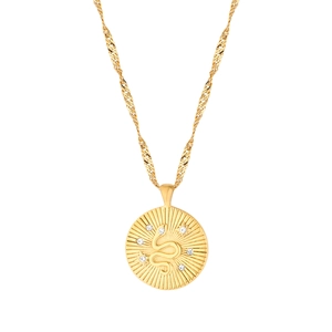 Detail of 18k gold plated sunburst necklace with central snake relief and white crystals