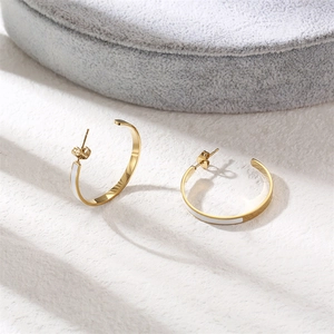 Elegant gold-finished C-shape hoop earrings featuring white enamel inlay and a stud back