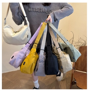 Nylon crescent crossbody bag displayed in seven colors with adjustable wide straps