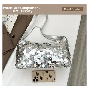 Silver sequin shoulder bag size comparison with a smartphone and metallic chain detail