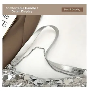 Detail view of silver sequin handbag with premium leather handle and metallic chain