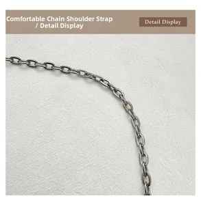 Close-up of polished silver metal chain strap with oval links for handbag detail