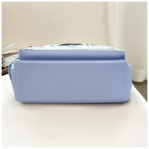 Close-up of the reinforced flat bottom of a light blue matte leather tote bag