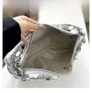Internal structure of silver sequin shoulder bag with zipper pocket and spacious lining