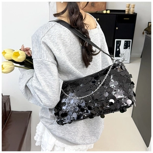 Close-up of black sequined shoulder bag with metallic chain and leather strap details