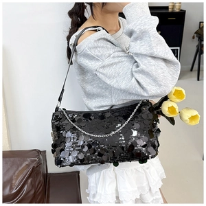 Detail of high-end black sequin shoulder bag with silver chain and glossy finish