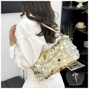Detail of trendy gold sequin underarm bag with chic metallic chain and leather strap