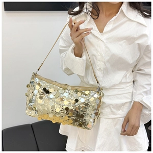Close-up of golden sequins on a stylish shoulder bag showing metallic reflective texture