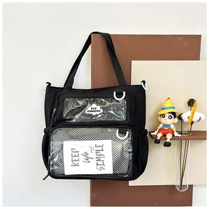 Detail of black canvas tote bag featuring double transparent PVC front pockets and cloud logo