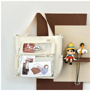 Close-up of cream white tote bag with clear front pockets and glossy waterproof finish