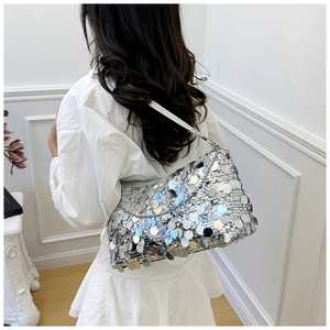 Fashionable bright silver sequin shoulder bag shown on model with metallic finish