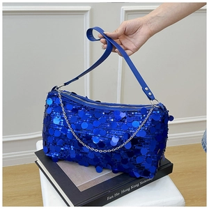 Royal blue sequin pillow shoulder bag with silver chain strap on decorative books