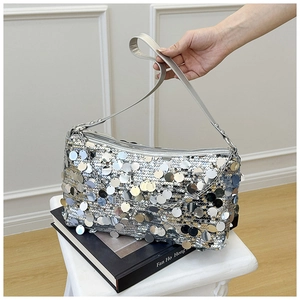 Close-up of silver sequin shoulder bag with metallic shine and faux leather strap