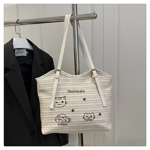 Fashionable beige woven beach tote bag with cute cat embroidery and adjustable straps