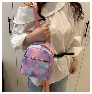 Detail of mini gradient backpack with heart patterns and gold floral zipper pull