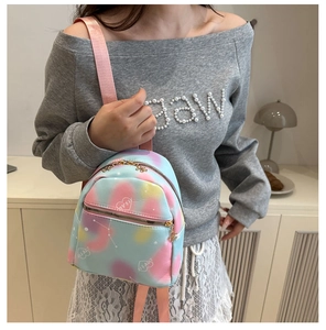 Detail of mini tie-dye backpack with white heart prints and gold-tone zippers
