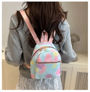 Macro view of multi-colored tie-dye mini backpack with love print and golden flower zipper