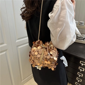Fashionable gold sequin bucket bag with elegant chain strap and pearl drawstring charms