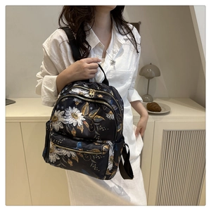 Floral print black backpack for women showing side view and large storage capacity