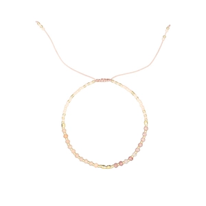 Detail of adjustable Morse code beaded bracelet with natural pink stones and gold accents