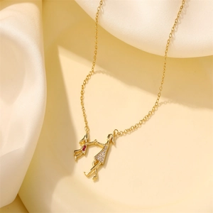 Golden mother and child pendant necklace with white crystals and red zircon on silk background