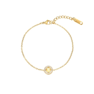 Detail of gold bracelet with round yellow gemstone and shimmering pavé zircon halo