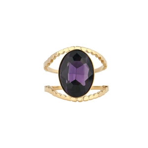 Macro shot of gold hollow wave band ring with large faceted oval purple gemstone