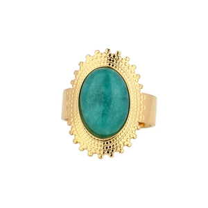 Detail of vintage gold ring with oval turquoise stone and radiant sunburst pattern