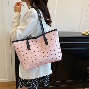 Pink pleated tote bag with black bow prints and long leather shoulder straps